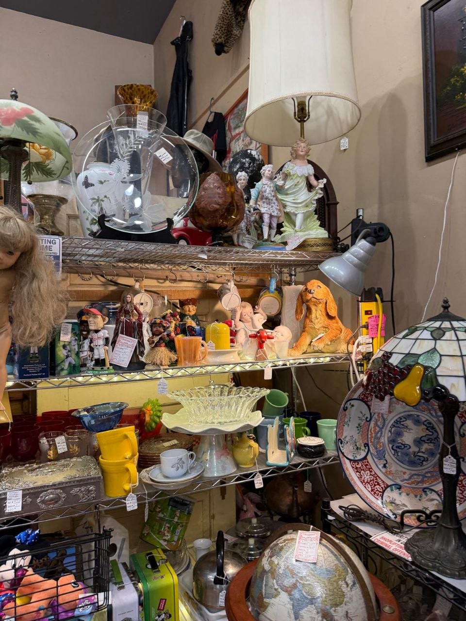 Eclectic vintage decor with a lamp, globe and figurines