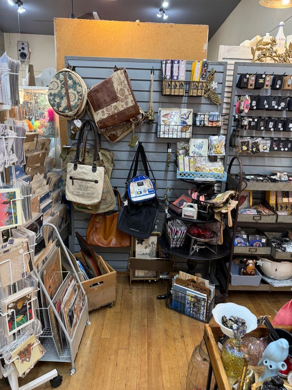 A wall display of colorful vintage handbags