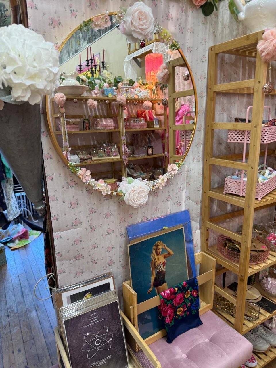Floral arched mirror, gold shelving and a pink bench inside Foxtrot Vintage